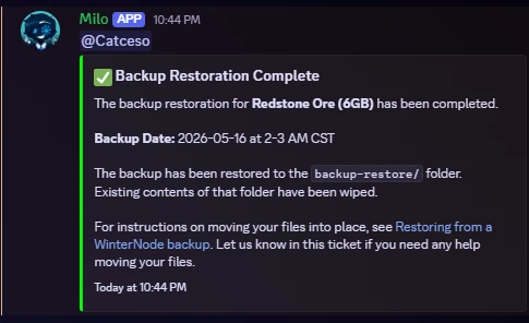 A "Backup Restoration Complete" message from the WinterNode bot confirming the restore for the affected service is done, noting the backup date and time and that the previous contents of the backup-restore folder have been wiped
